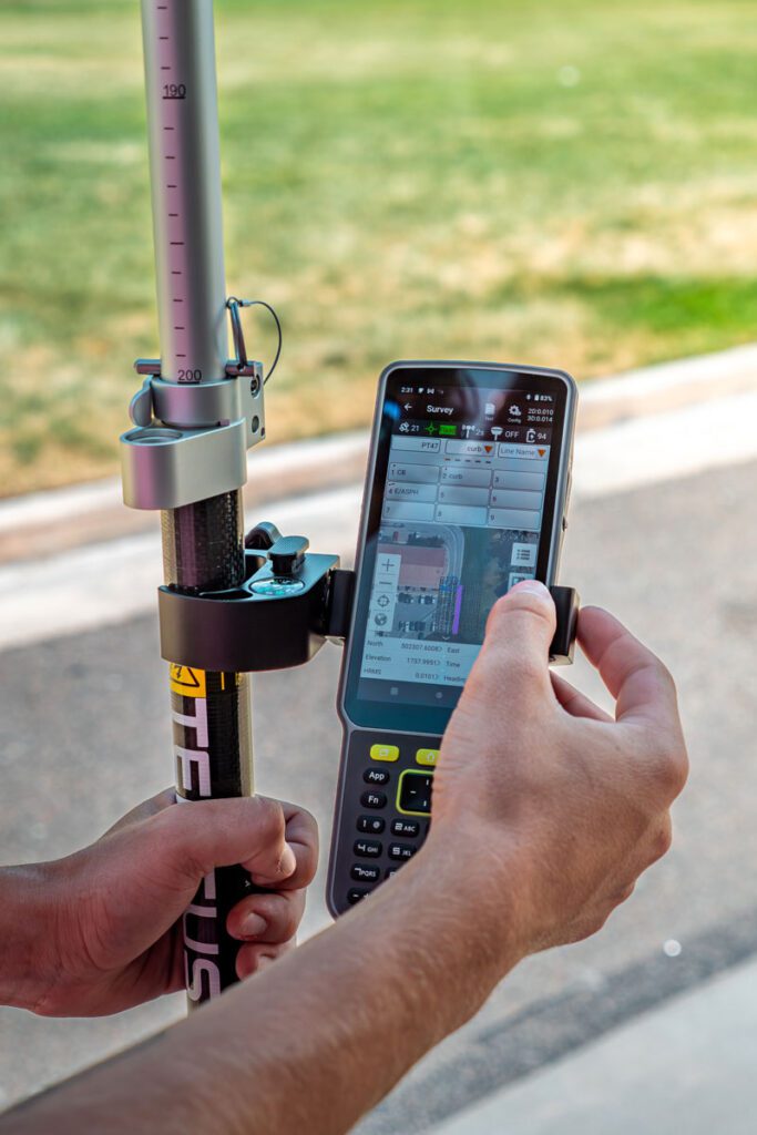 Image of a man using the Tersus TC80 attached to another Tersus device pole.